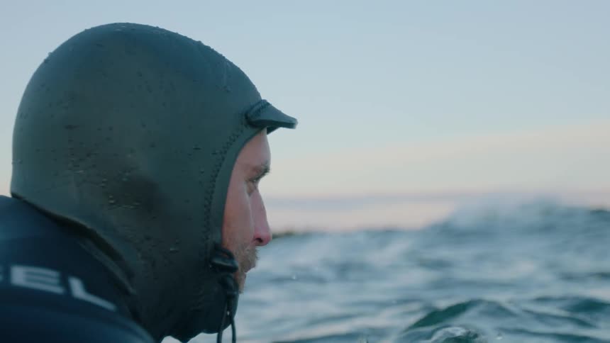 Man in a wetsuit near the surface of the water