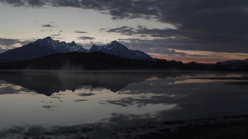 Water rolls into shore under a cloudy sky