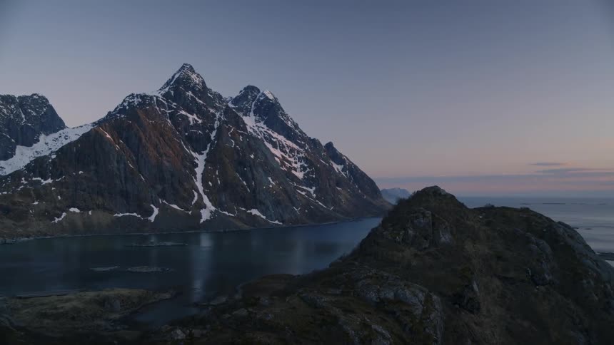 The mountain is tall and covered with snow