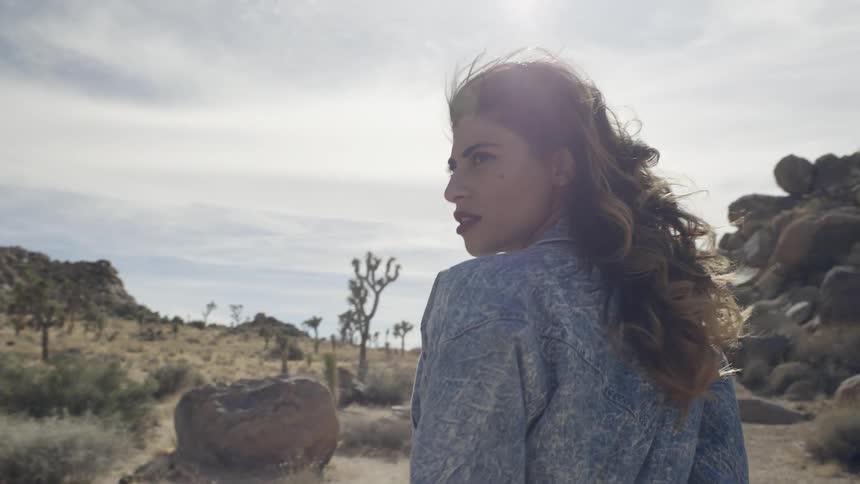 A woman walks through the desert