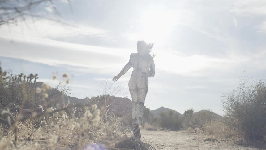 A woman runs happily outside