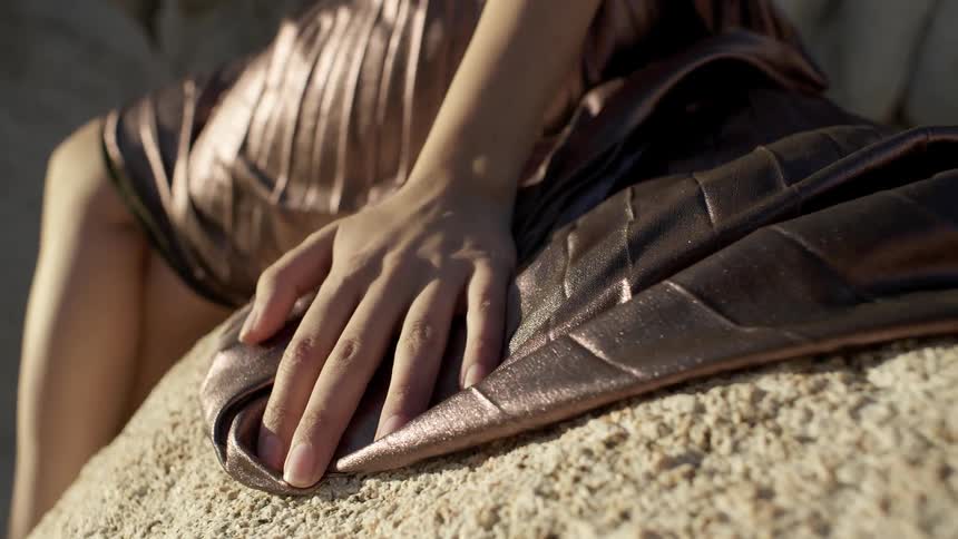 A woman's dress is blown by the wind