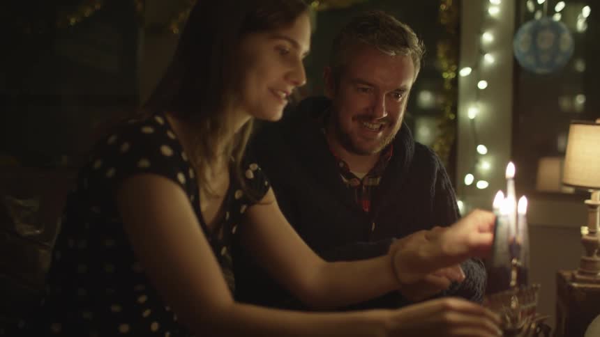 A couple is lighting candles