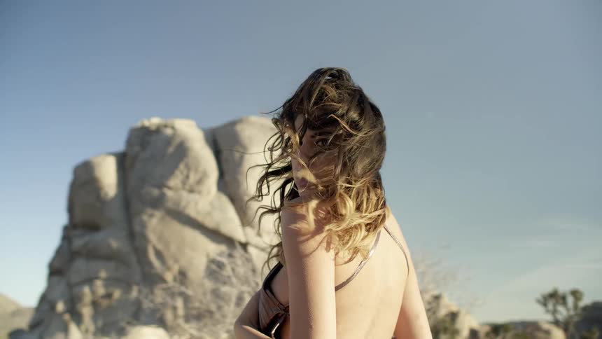 A woman walks outside in the breeze