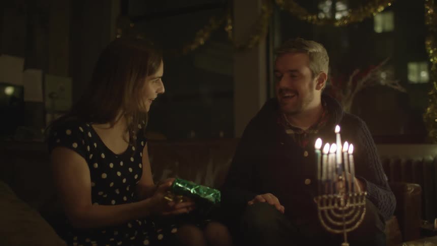 A man gives a woman a gift