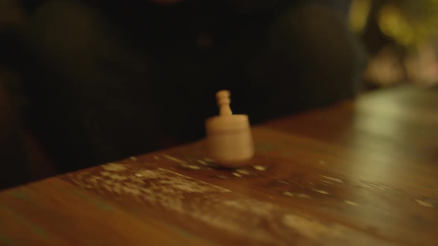 A person spinning a dreidel
