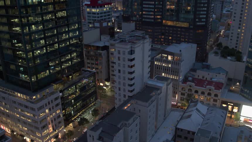Vehicles travel on a city road at night