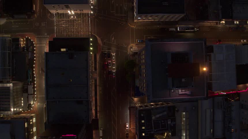 Vehicles travel on a city road at night