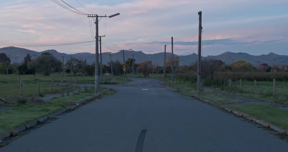 Power lines hang next to a desolate road