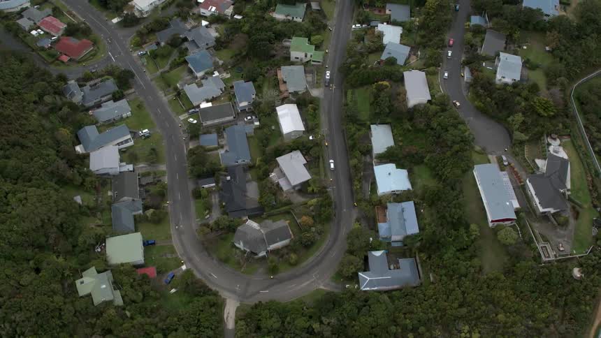 A u shaped turn is surrounded by houses
