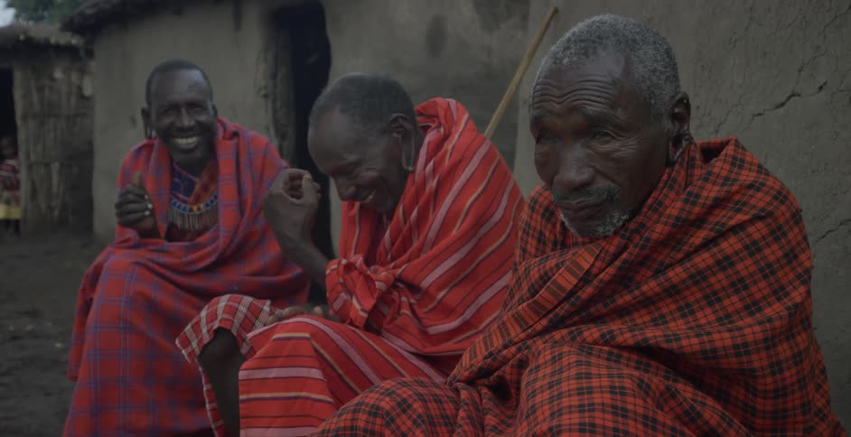 A group of maasai men sit and converse