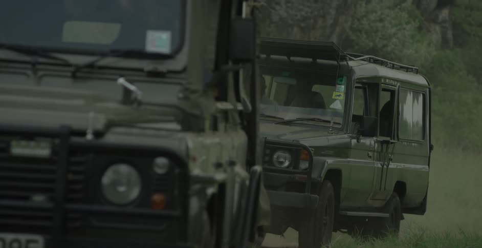 Trucks travel on a dirt road