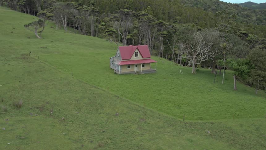 A lone house sits on the hill