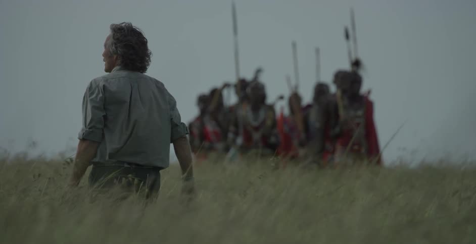 A group of maasai march through the field