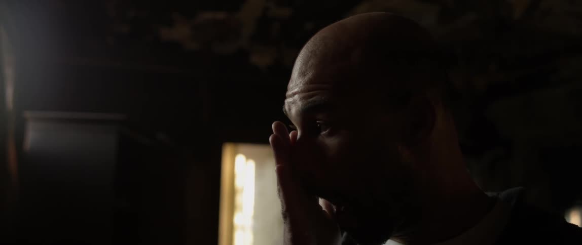A man holds his hand up to his face