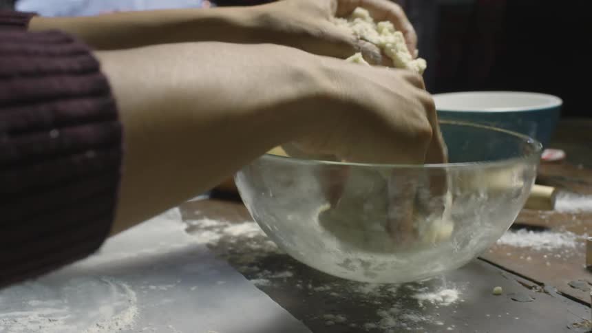 A person is preparing to cook some bread
