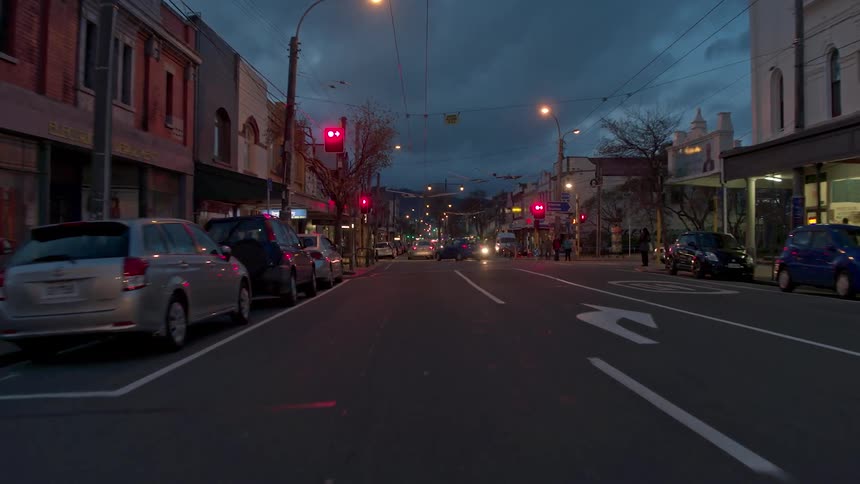 Vehicles travel on a city road at night