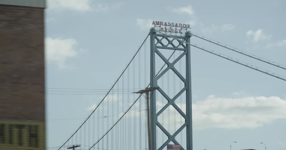 The tall bridge has a sign at the very top