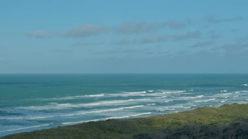 Waves flow onto the beach shore
