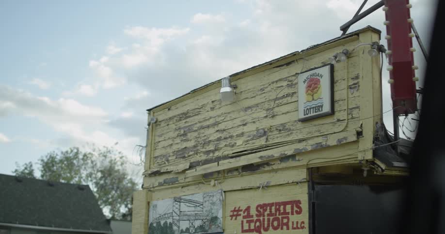 Barbed wire is strewn on top of a liquor store