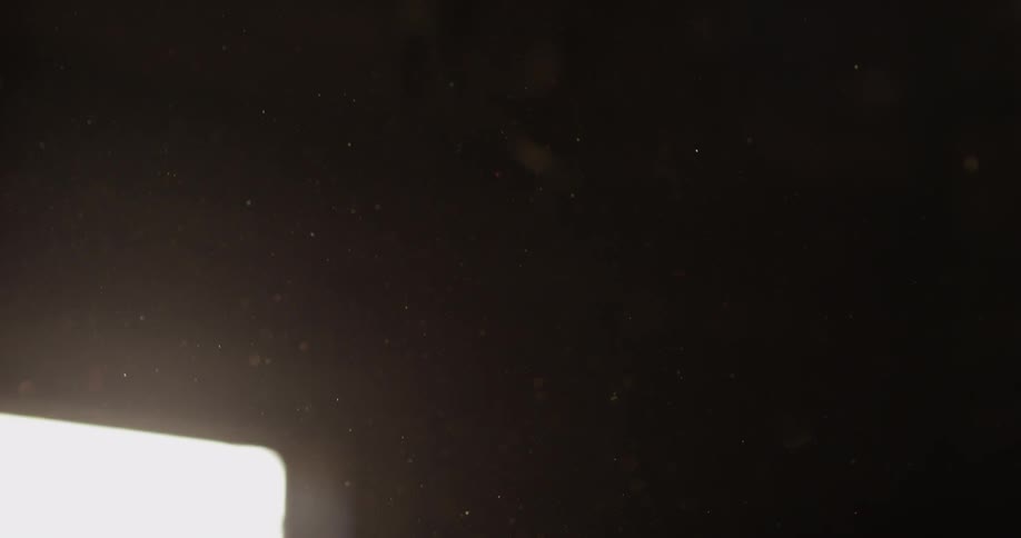 Dust floats in a dark room
