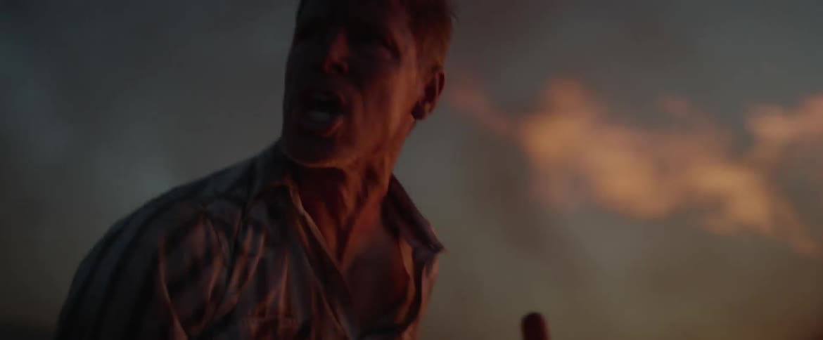 Two men frantically shovel dirt on a fire