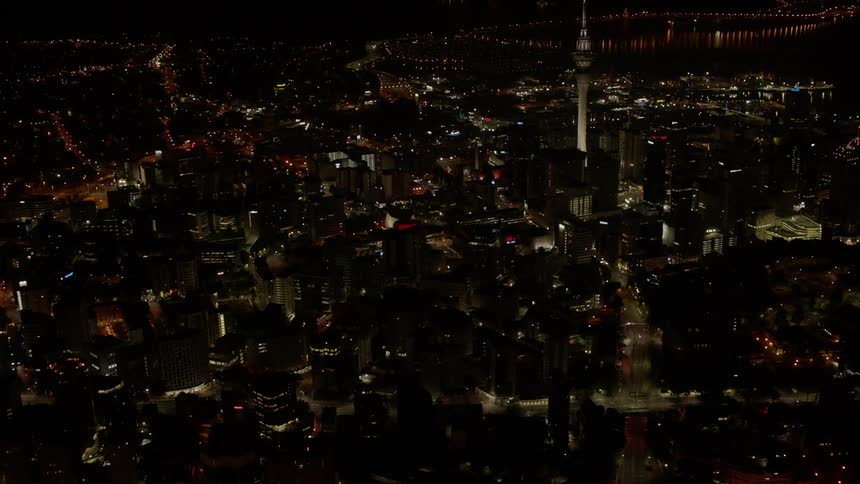 Lights illuminate buildings in a city at night