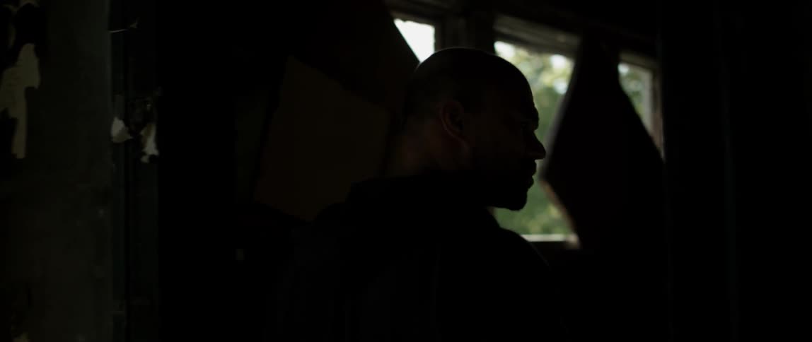 Man walks through a doorway into another room