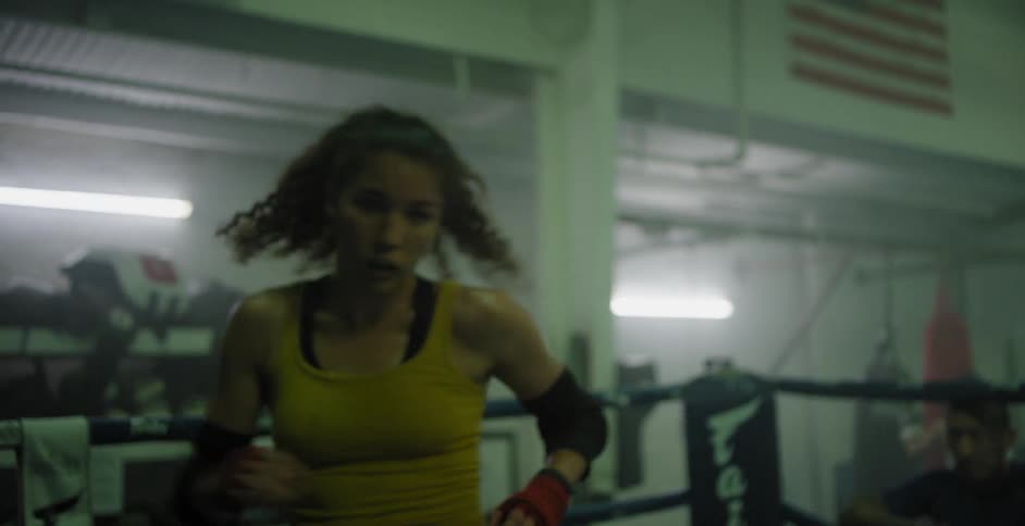 A woman shadow boxes in a boxing ring