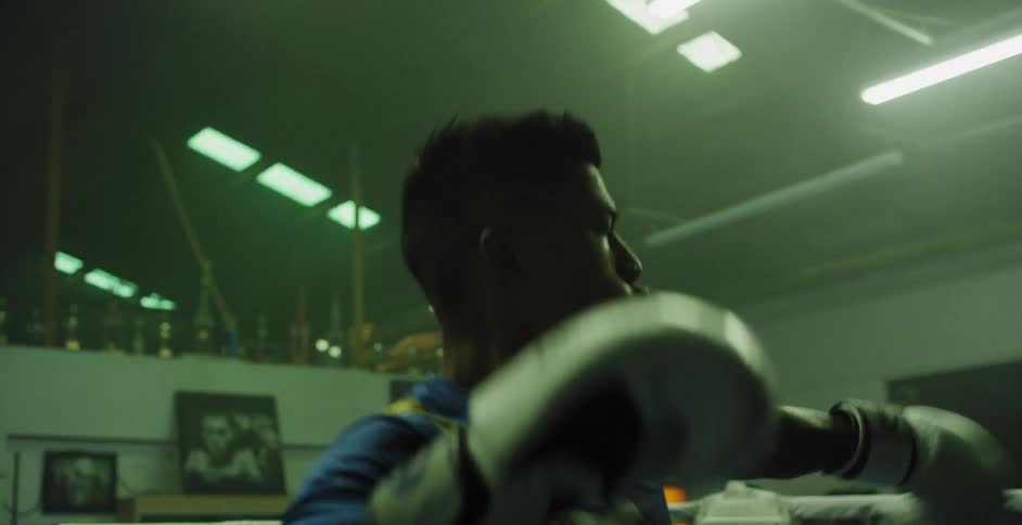 A woman practices sparring in the ring