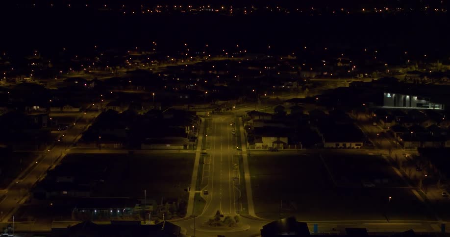 Lamp posts illuminate the road at night