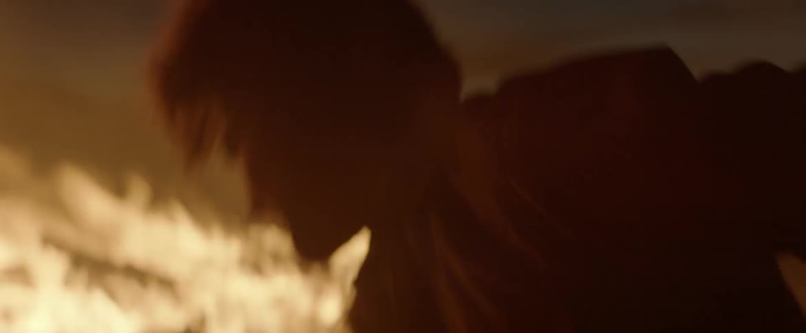 A man is shoveling fast into a large fire