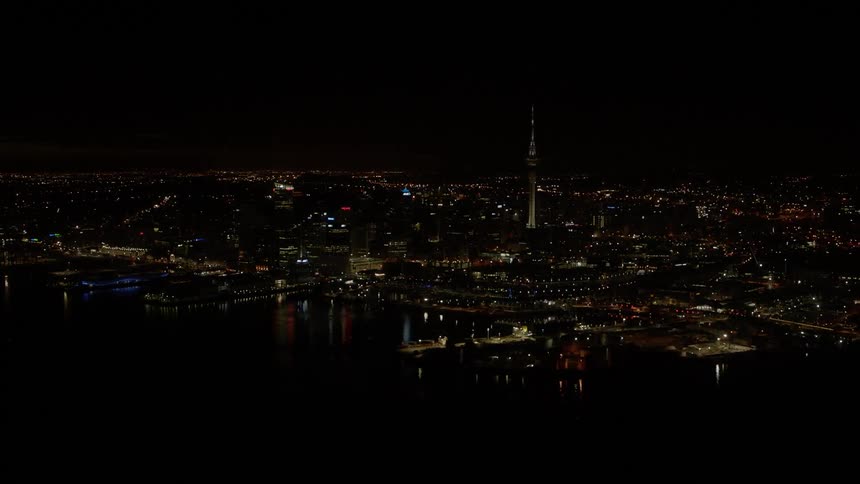 City buildings illuminate the night sky