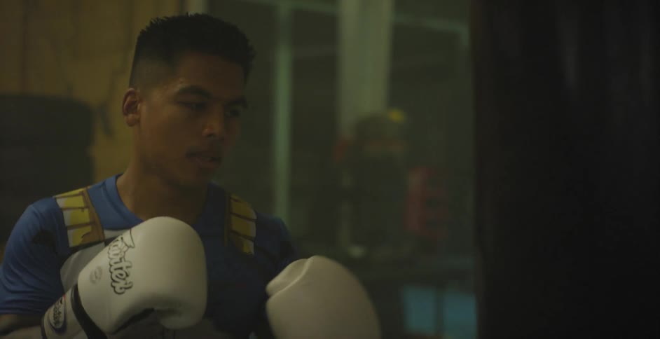 Man punches and kicks a punching bag