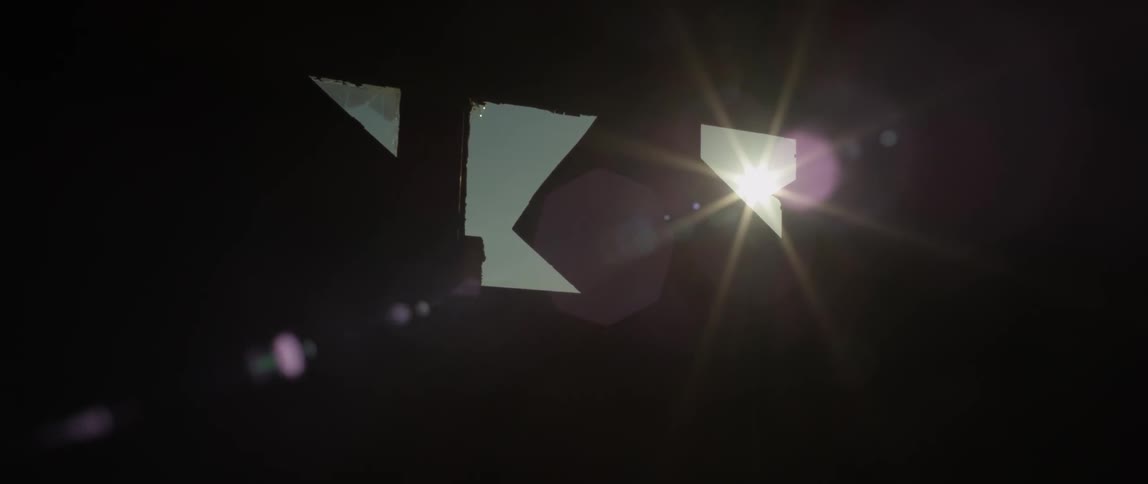 The sun moves in the sky beyond boarded up windows