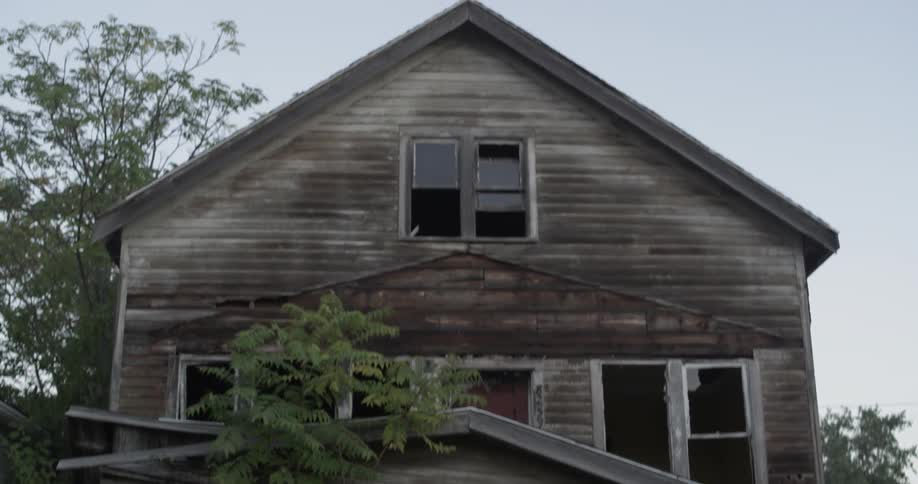 A tattered building leans outside