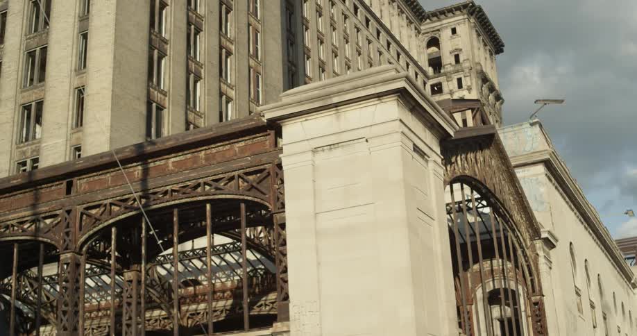 The tall building is made of stone with many windows