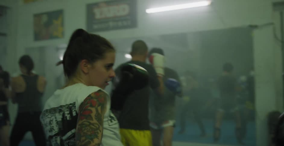 Athletes train sparring in a gym