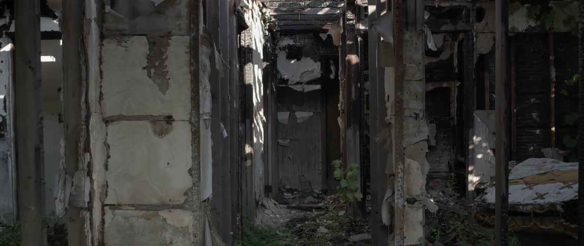 Tattered walls are inside an abandoned house
