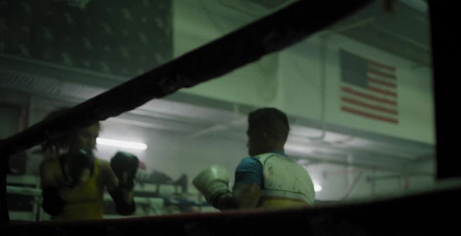Fighters spar in a boxing ring