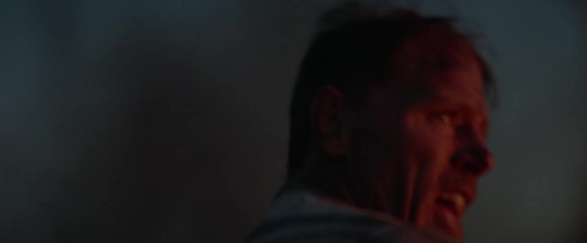 A man frantically attempts to extinguish a fire