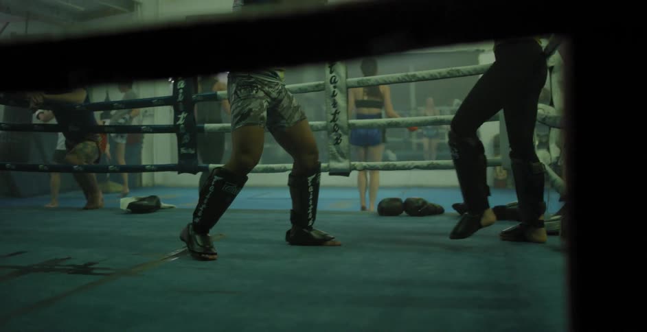 Fighters spar in a boxing ring