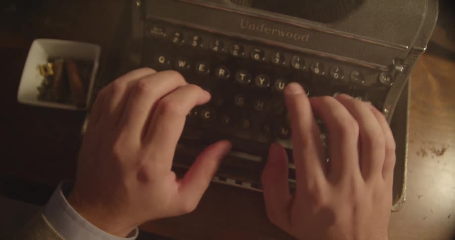 A person is preparing to type while smoking