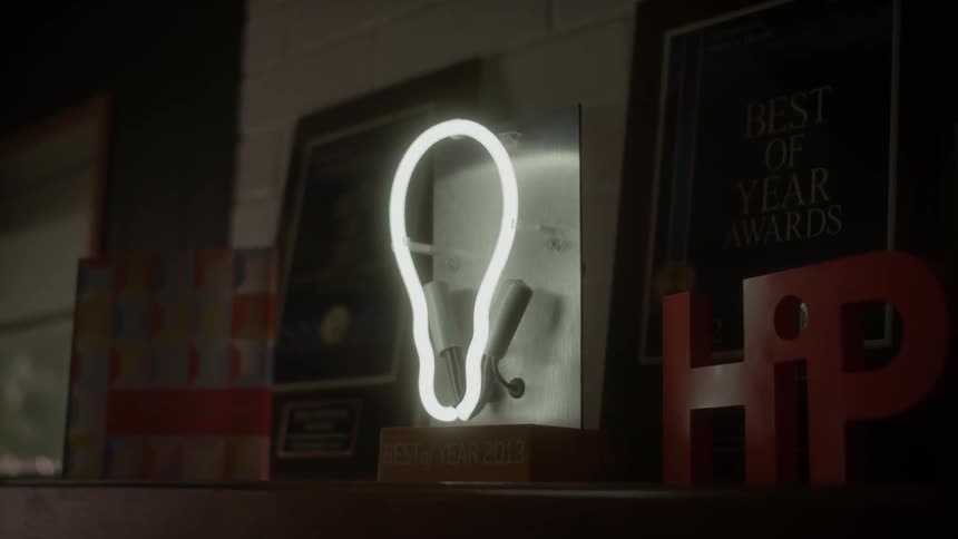 A neon light bulb sign is lit up