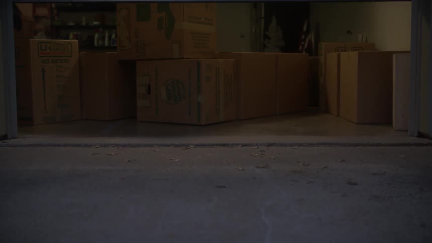 Garage door opens to reveal boxes