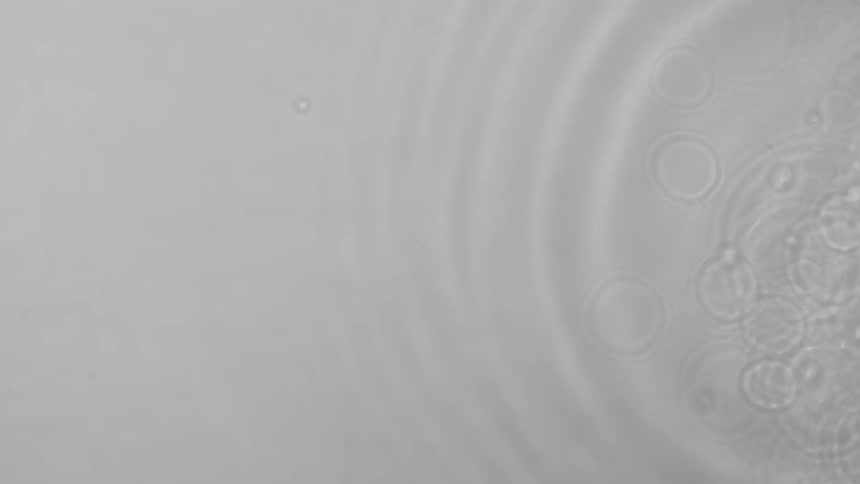 White liquid ripples as droplets fall
