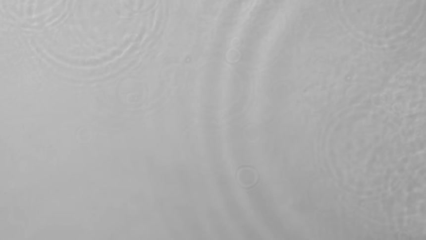 Drops of water rain into the clear water