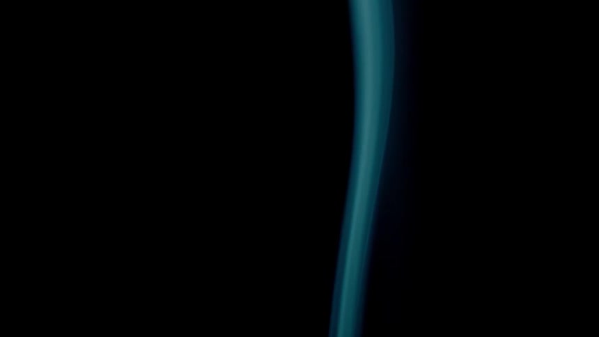 Blue smoke is filmed with a black background
