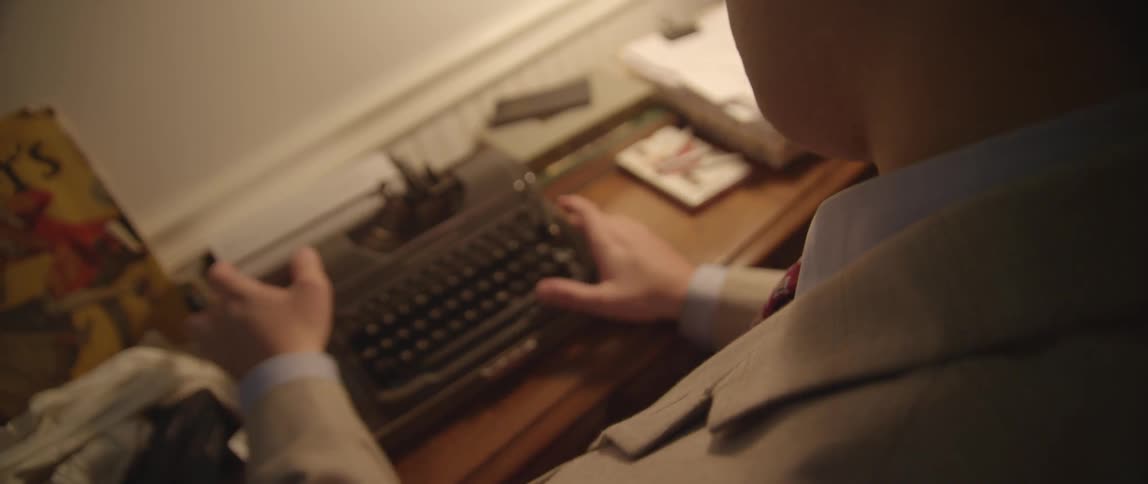 A man typing on a typewriter