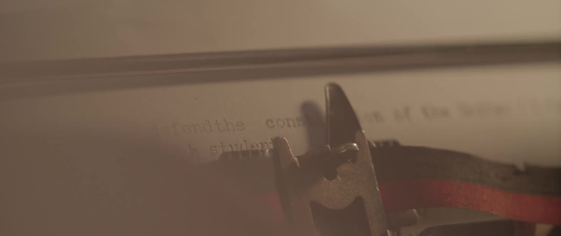 A person types at a typewriter